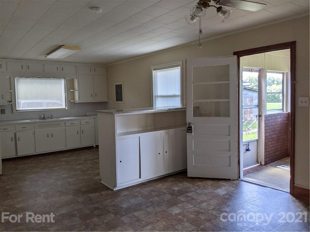 401 Gribble Road Matthews, NC 28104 - Photo 4 of 13 a view of a kitchen with a sink and dishwasher cabinets