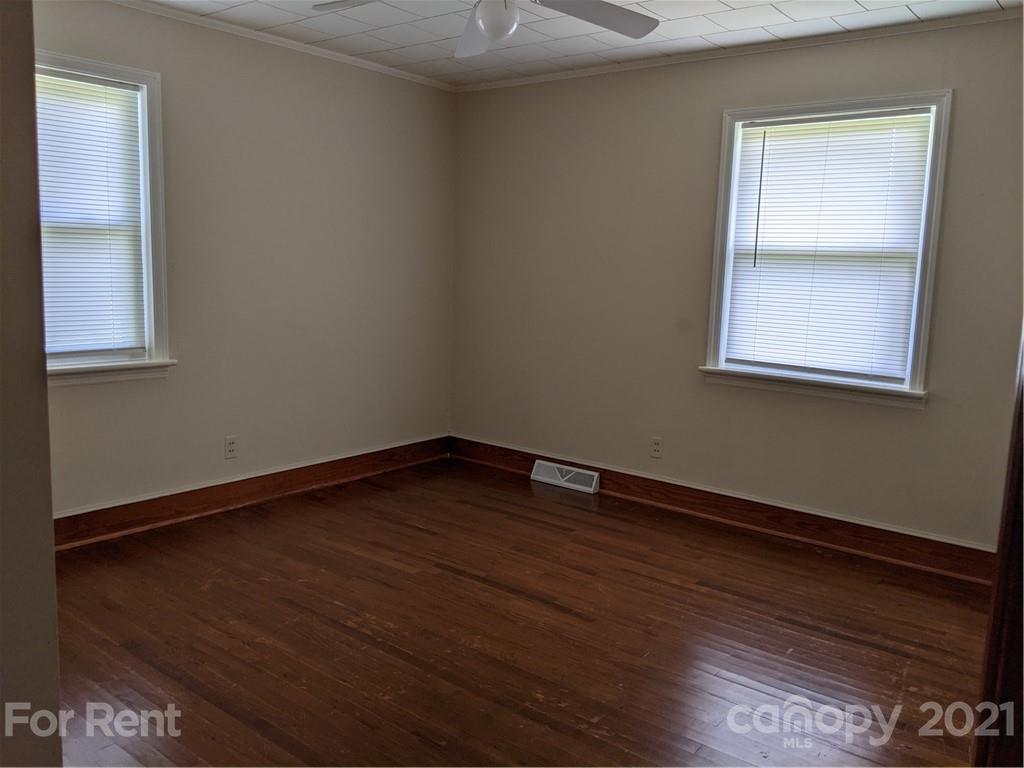 401 Gribble Road Matthews, NC 28104 - Photo 9 of 13 a view of an empty room with wooden floor and a window