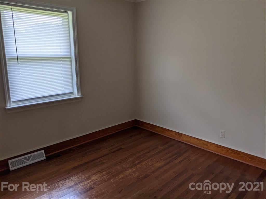 401 Gribble Road Matthews, NC 28104 - Photo 10 of 13 a view of a small space with wooden floor and a window