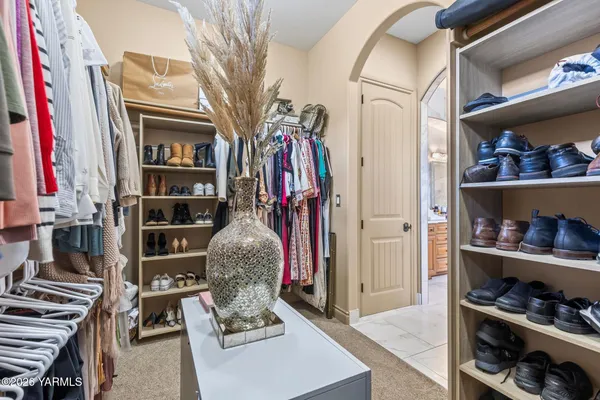 a kitchen with stainless steel appliances kitchen island granite countertop a refrigerator and a stove top oven