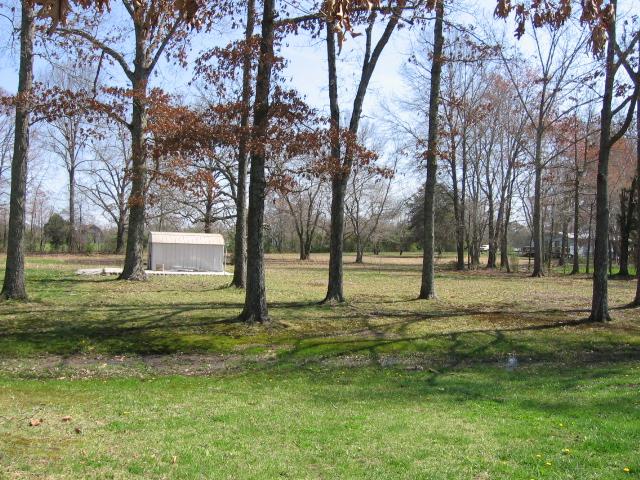 212 Carter Blake Road Tullahoma, TN 37388 - Photo 16 of 20 This large lot includes lots of trees for shade and a storage shed.