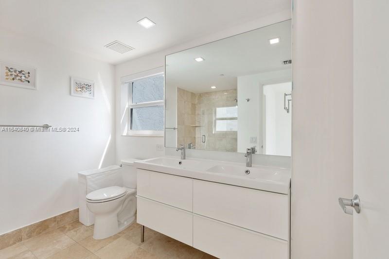 2475 Brickell Avenue, Unit 1606 Miami, FL 33129 - Photo 14 of 21 a bathroom with a toilet a sink and mirror