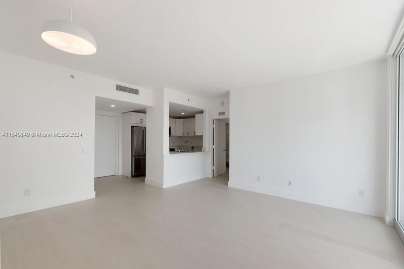 2475 Brickell Avenue, Unit 1606 Miami, FL 33129 - Photo 2 of 21 a view of a kitchen with refrigerator and a sink