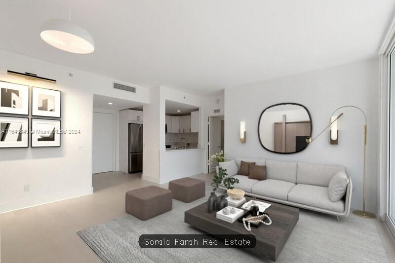 2475 Brickell Avenue, Unit 1606 Miami, FL 33129 - Photo 6 of 21 a living room with furniture a rug and a mirror