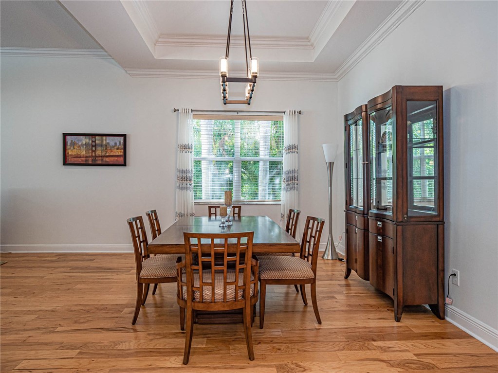 4229 Diamond Square Vero Beach, FL 32967 - Photo 12 of 36 a view of a dining room with furniture window and wooden floor
