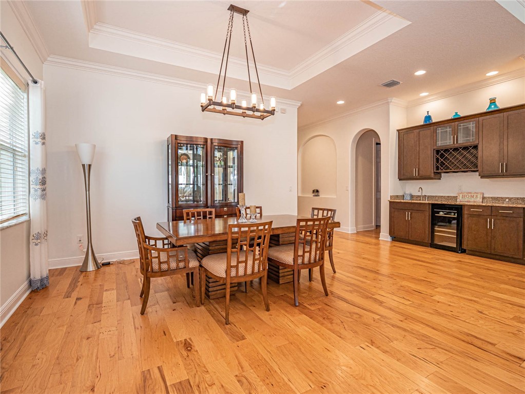4229 Diamond Square Vero Beach, FL 32967 - Photo 13 of 36 a view of a dining room with furniture window and wooden floor