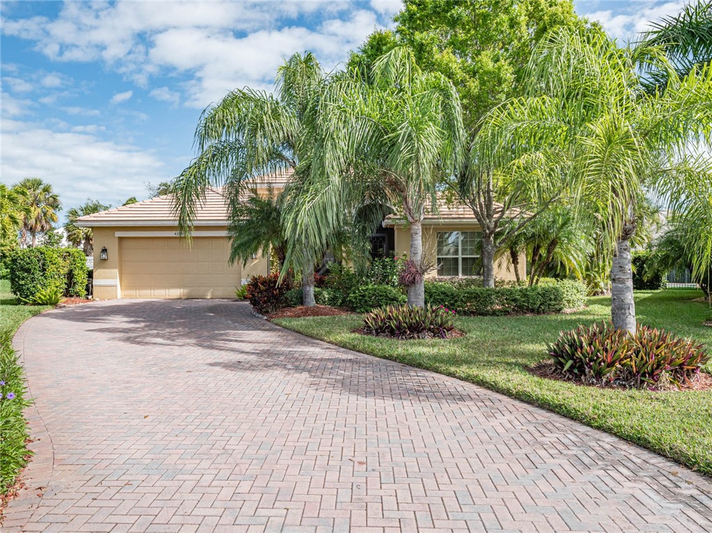 4229 Diamond Square Vero Beach, FL 32967 - Photo 2 of 36 a front view of a house with a garden