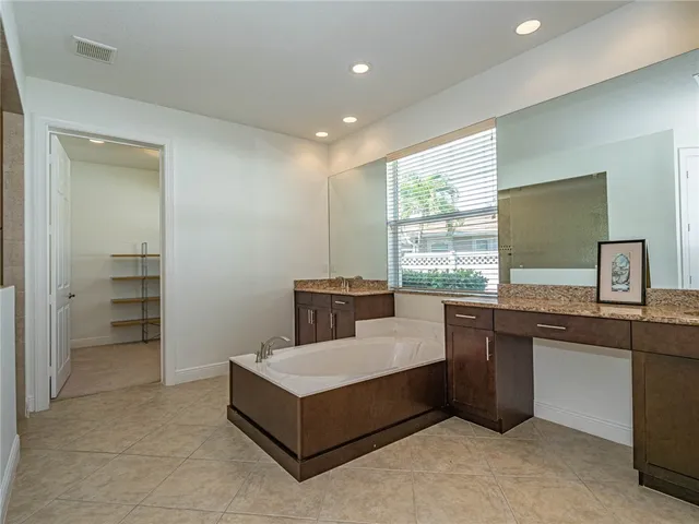 a spacious bedroom with a bed and a window