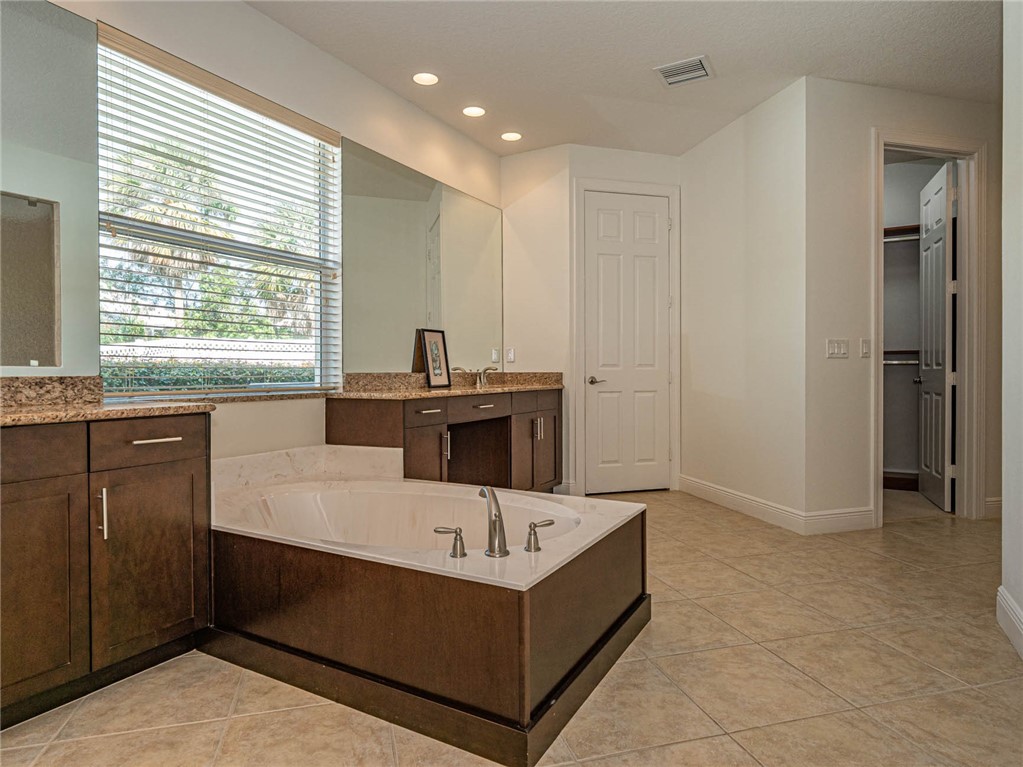 4229 Diamond Square Vero Beach, FL 32967 - Photo 25 of 36 a kitchen with a sink a counter top space and windows