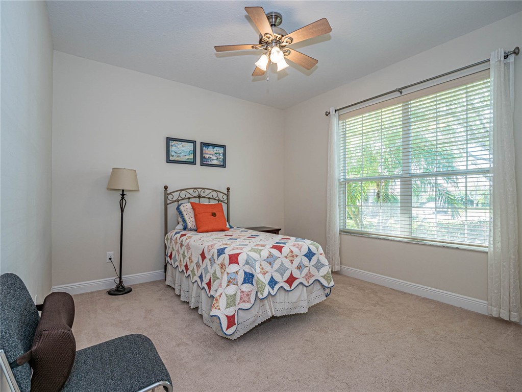4229 Diamond Square Vero Beach, FL 32967 - Photo 29 of 36 a bedroom with a bed and a window