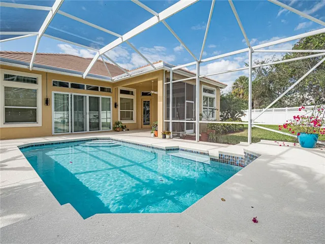 a view of a house with a backyard and a patio