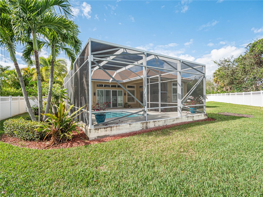 4229 Diamond Square Vero Beach, FL 32967 - Photo 35 of 36 a view of a backyard with table and chairs and potted plants