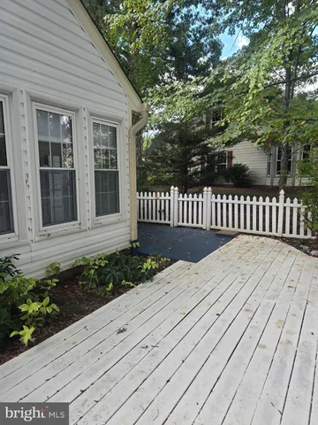 a view of a yard with wooden fence