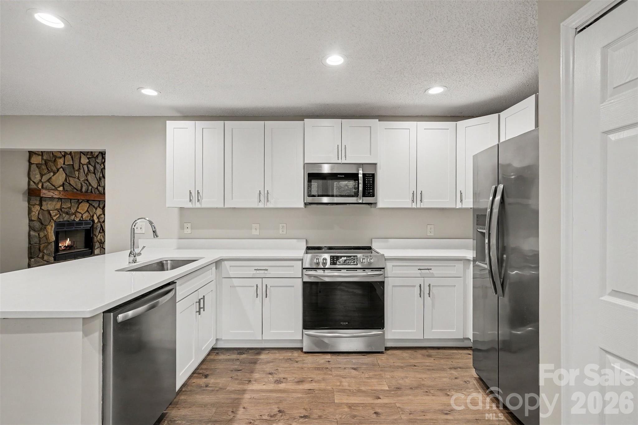 9060 Tulagi Court Tega Cay, SC 29708 - Photo 11 of 29 a kitchen with a sink stove and refrigerator