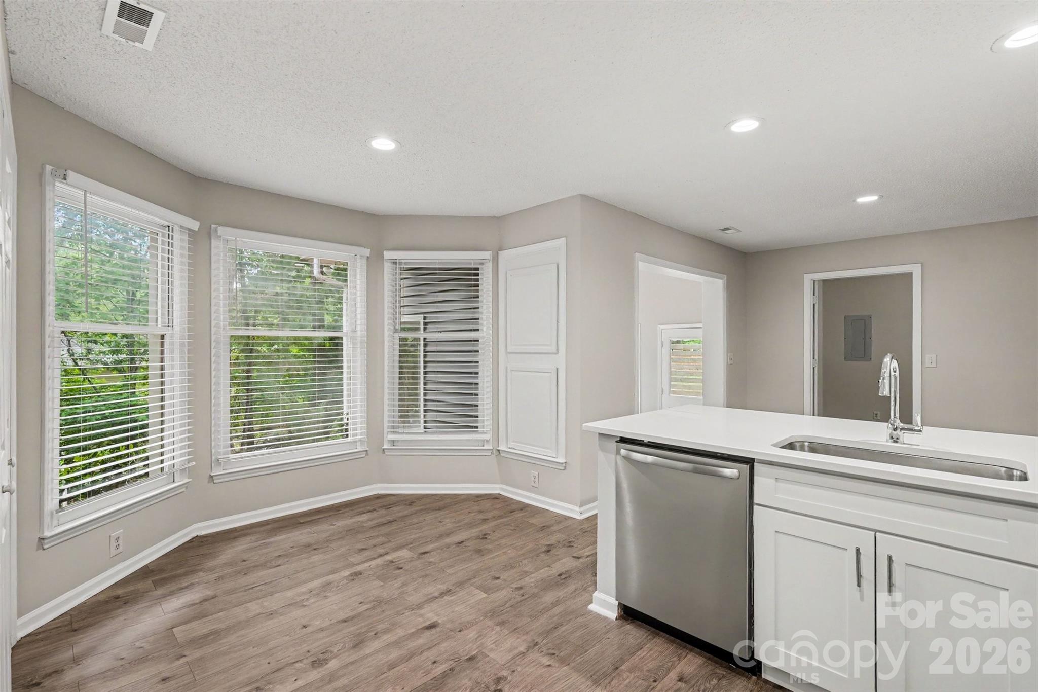 9060 Tulagi Court Tega Cay, SC 29708 - Photo 14 of 29 a view of a kitchen with a sink dishwasher and wooden floor