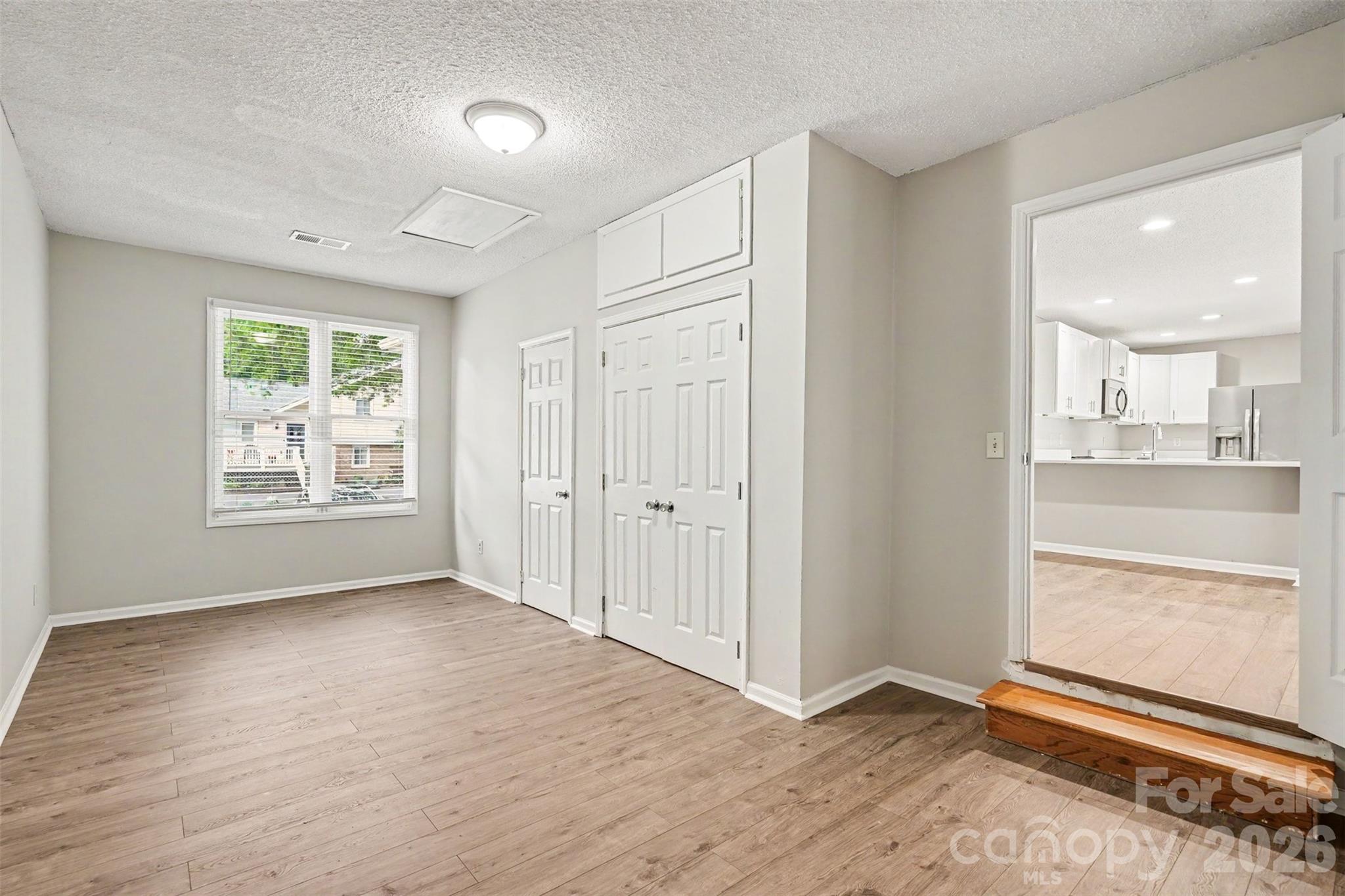 9060 Tulagi Court Tega Cay, SC 29708 - Photo 18 of 29 wooden floor in an empty room with a window