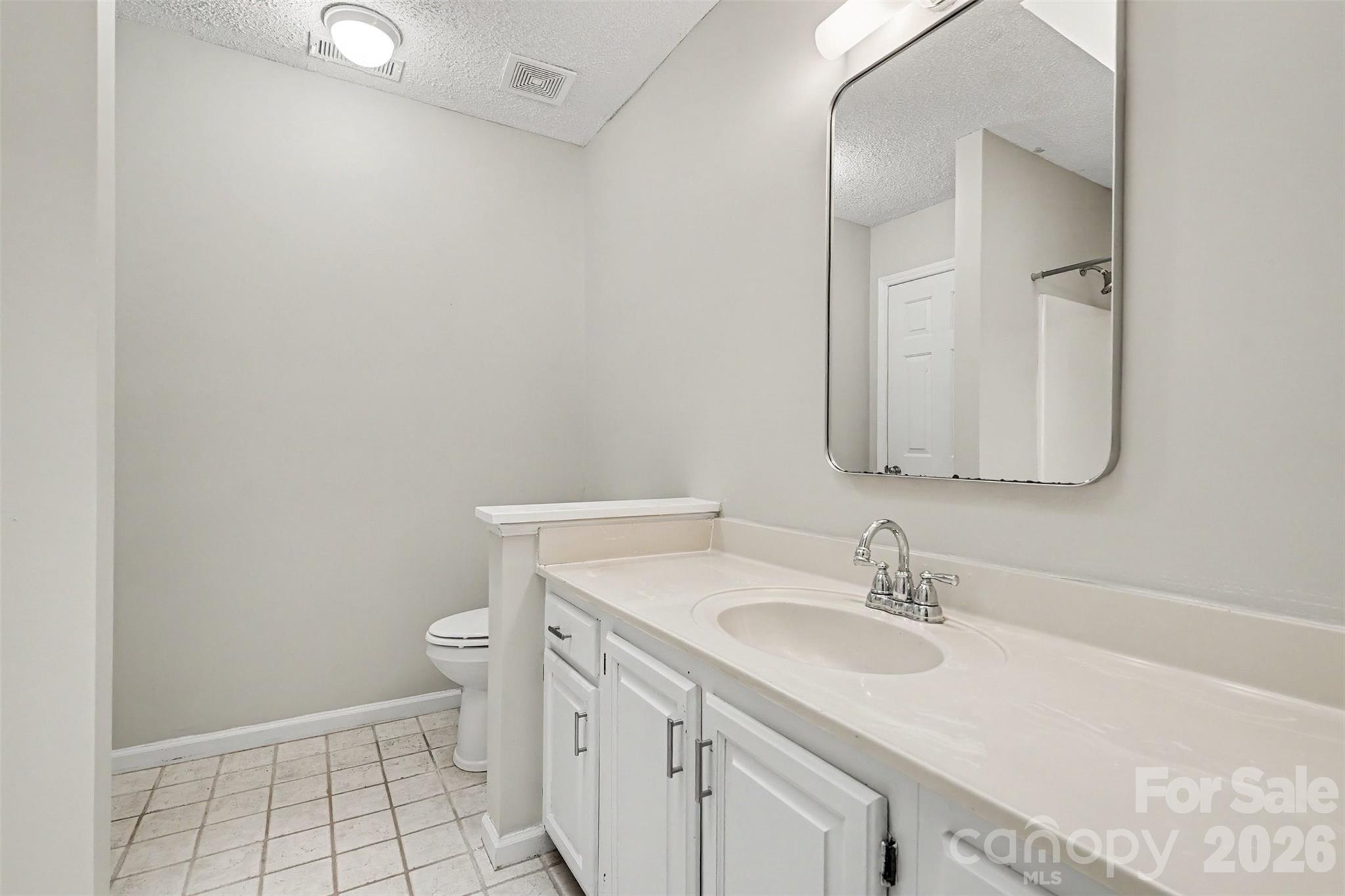 9060 Tulagi Court Tega Cay, SC 29708 - Photo 22 of 29 a bathroom with a sink toilet and vanity