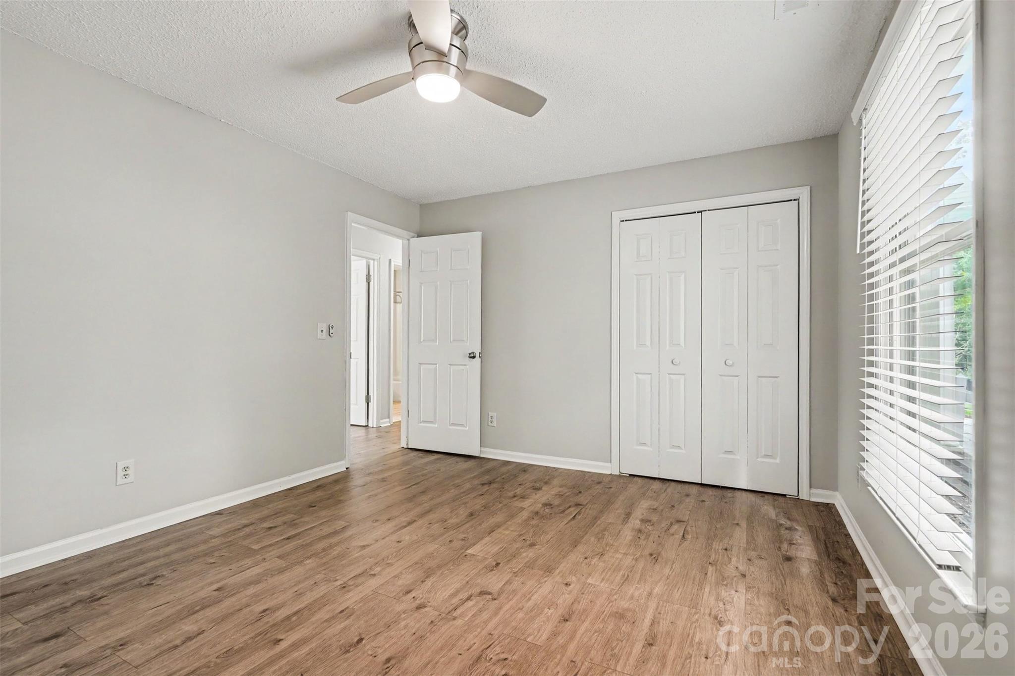 9060 Tulagi Court Tega Cay, SC 29708 - Photo 28 of 29 a view of an empty room with wooden floor and a window