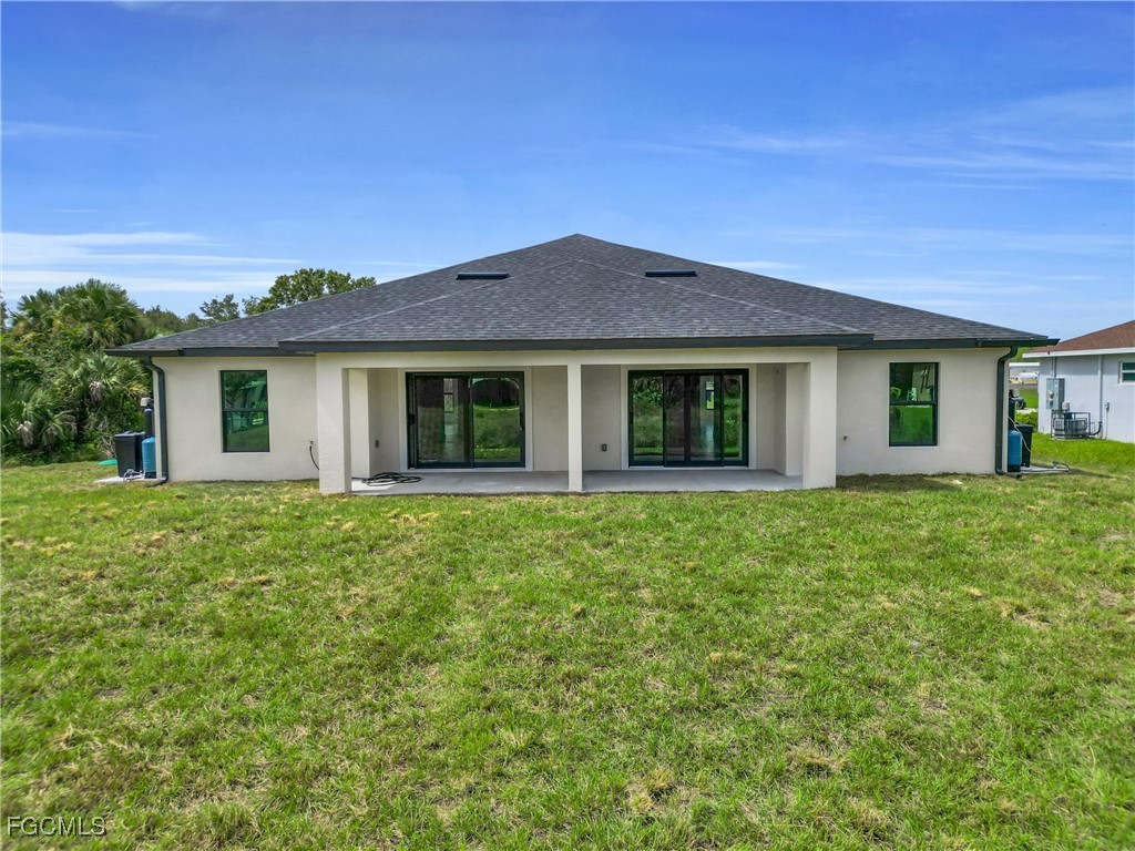 2508-2510 Park Road Lehigh Acres, FL 33971 - Photo 6 of 37 a front view of a house with a garden