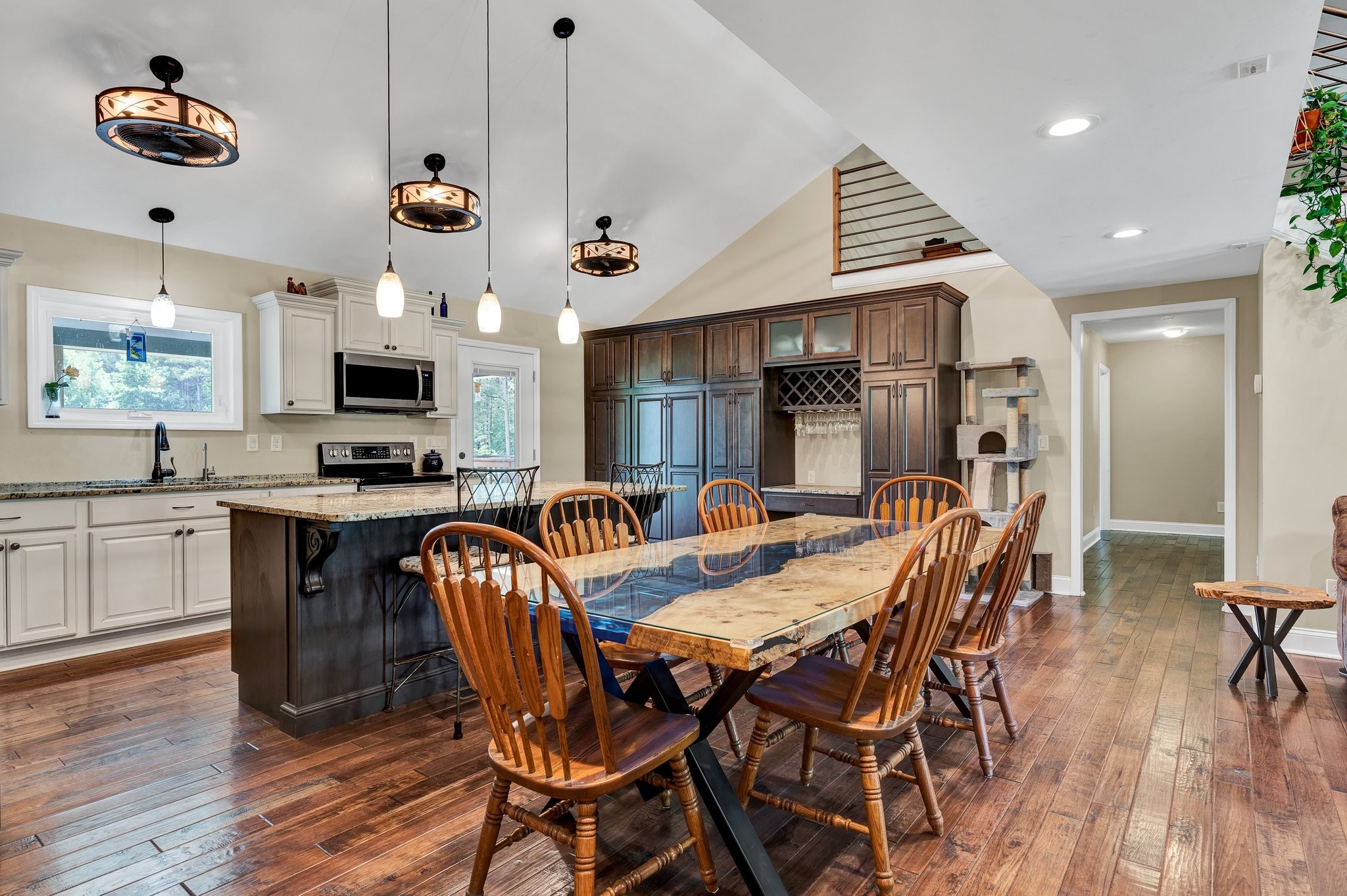 1600 Union Road Southeast Cleveland, TN 37323 - Photo 9 of 68 a kitchen with stainless steel appliances kitchen island granite countertop a stove top oven a sink a dining table and chairs with wooden floor