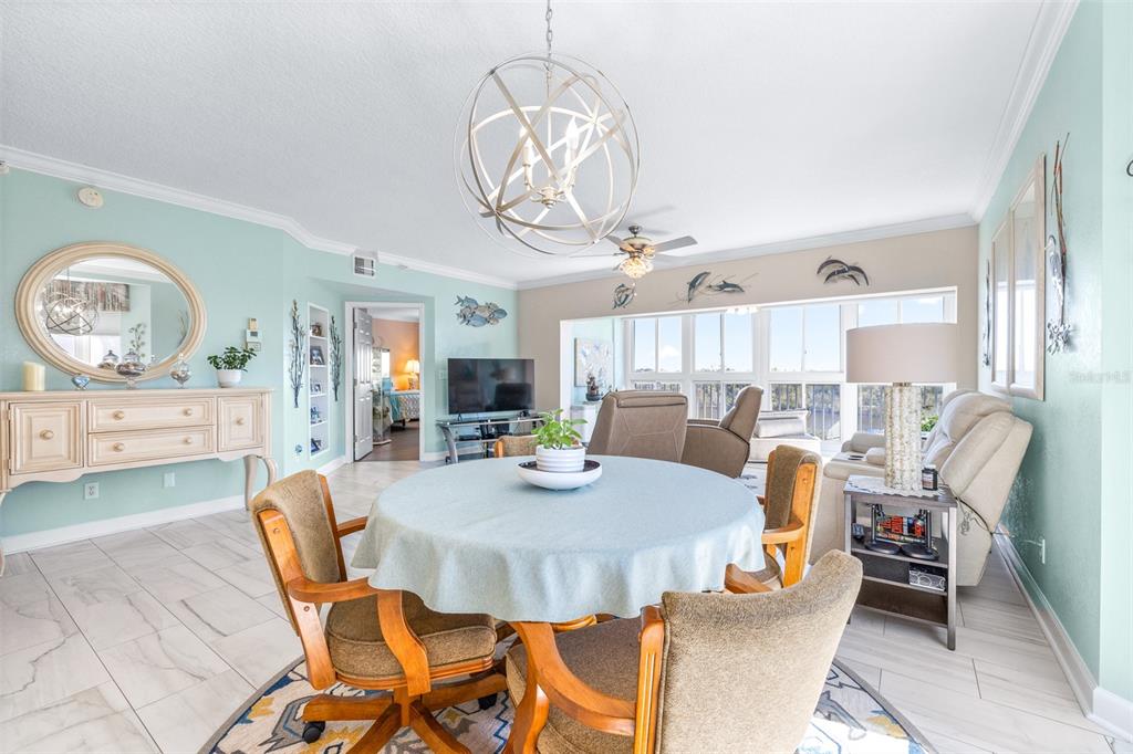 6399 Shoreline Drive, Unit 4206 St. Petersburg, FL 33708 - Photo 11 of 40 a view of a dining room with furniture window and wooden floor