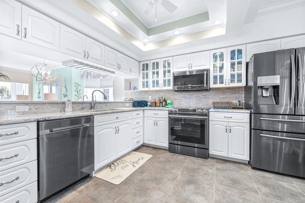 6399 Shoreline Drive, Unit 4206 St. Petersburg, FL 33708 - Photo 12 of 40 a kitchen with a refrigerator stove top oven and sink