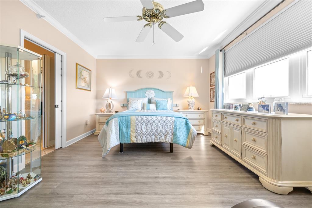 6399 Shoreline Drive, Unit 4206 St. Petersburg, FL 33708 - Photo 15 of 40 a bedroom with a bed and a dresser next to a window