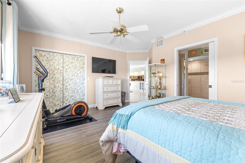 6399 Shoreline Drive, Unit 4206 St. Petersburg, FL 33708 - Photo 16 of 40 a bedroom with a bed and a flat screen tv