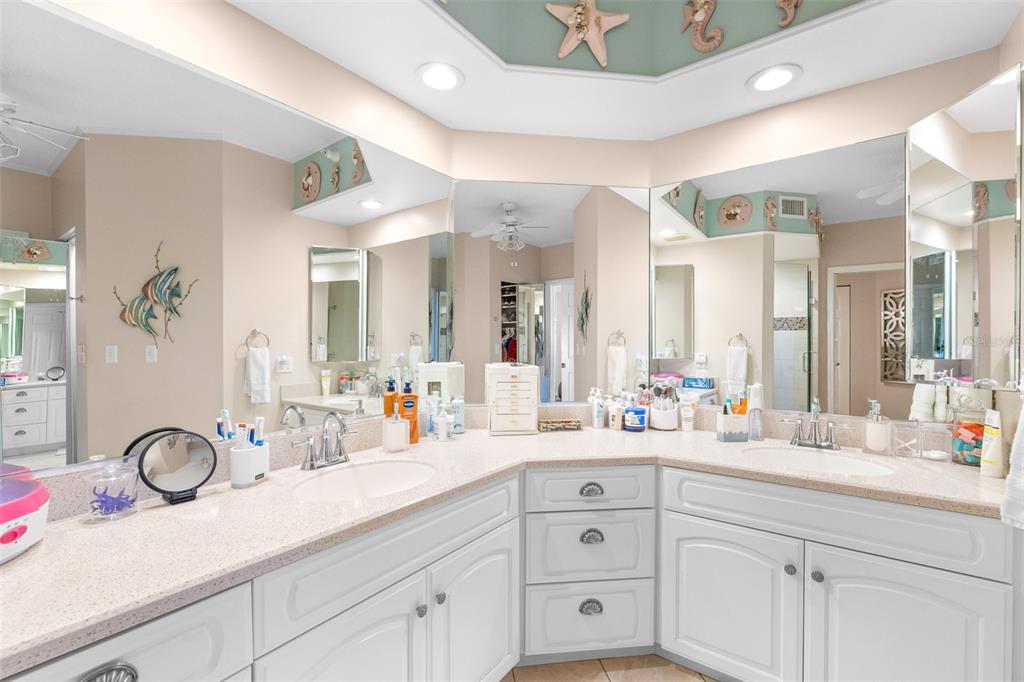 6399 Shoreline Drive, Unit 4206 St. Petersburg, FL 33708 - Photo 17 of 40 a bathroom with a sink and a mirror