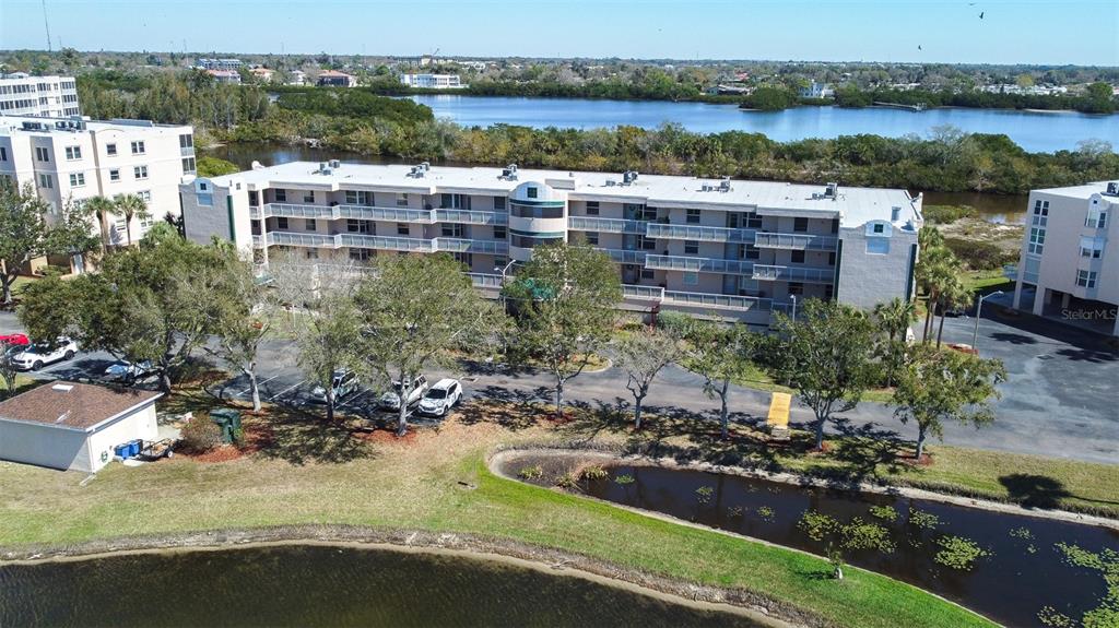 6399 Shoreline Drive, Unit 4206 St. Petersburg, FL 33708 - Photo 36 of 40 a view of a lake with a building and trees in the background