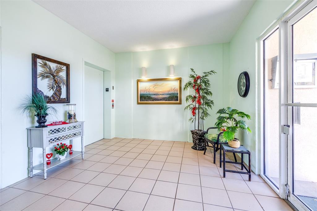 6399 Shoreline Drive, Unit 4206 St. Petersburg, FL 33708 - Photo 39 of 40 a living room with furniture and a potted plant