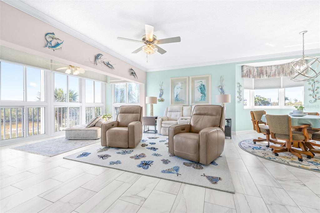 6399 Shoreline Drive, Unit 4206 St. Petersburg, FL 33708 - Photo 4 of 40 a living room with furniture and a floor to ceiling window