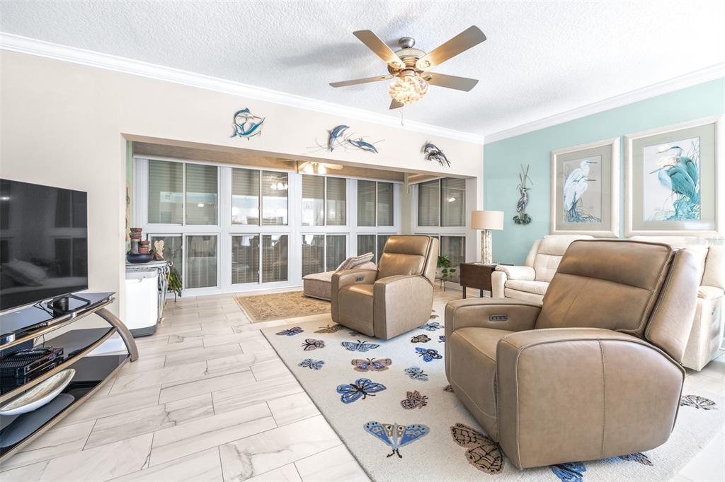 6399 Shoreline Drive, Unit 4206 St. Petersburg, FL 33708 - Photo 6 of 40 a living room with furniture and a flat screen tv