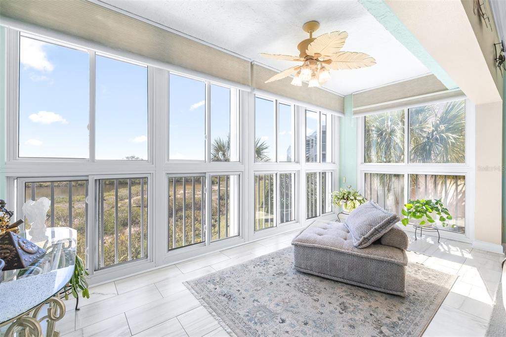 6399 Shoreline Drive, Unit 4206 St. Petersburg, FL 33708 - Photo 7 of 40 a living room with furniture and large windows