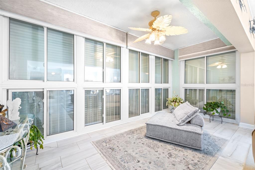 6399 Shoreline Drive, Unit 4206 St. Petersburg, FL 33708 - Photo 8 of 40 a living room with furniture and large windows