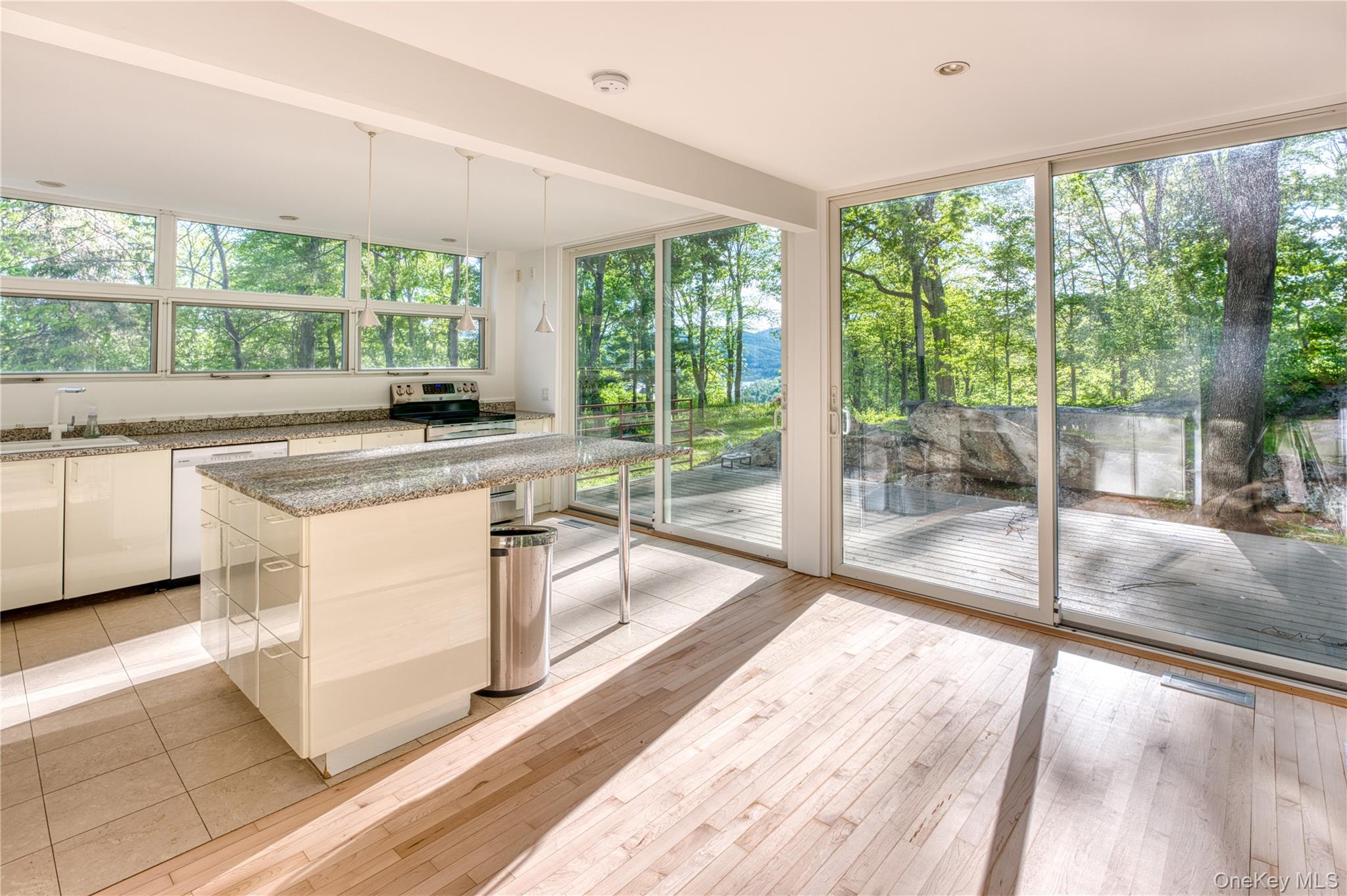 61 Indian Brook Road Garrison, NY 10524 - Photo 10 of 23 a view of a kitchen with a sink and a large window