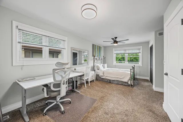 a living room with furniture a dining table and a window