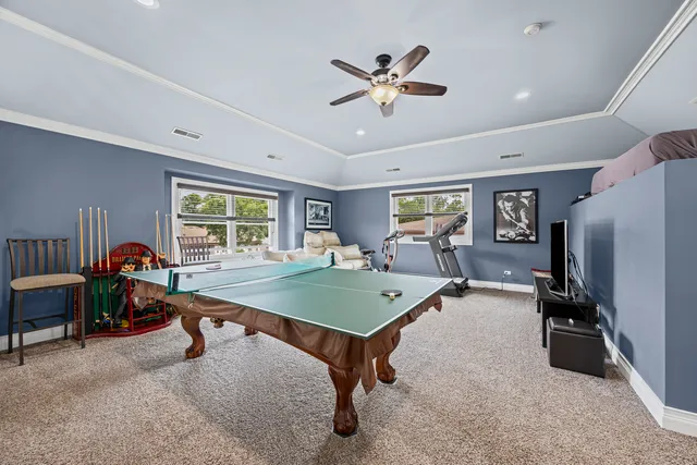 a room with furniture pool table and windows