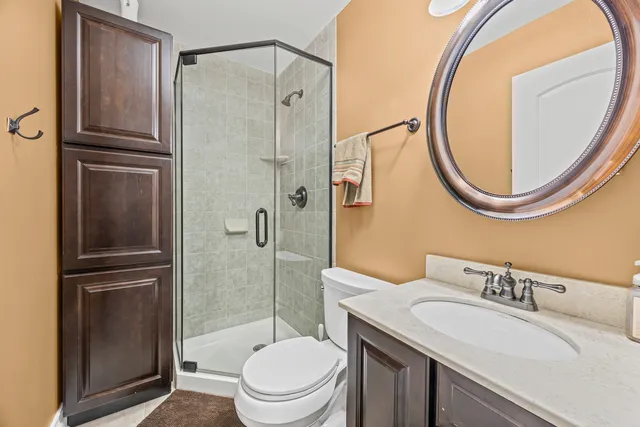 a bathroom with a granite countertop toilet sink and shower