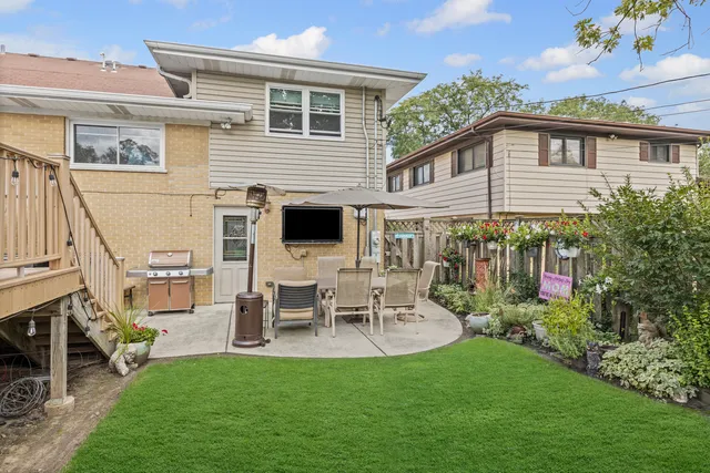 a view of a house with patio and a garden