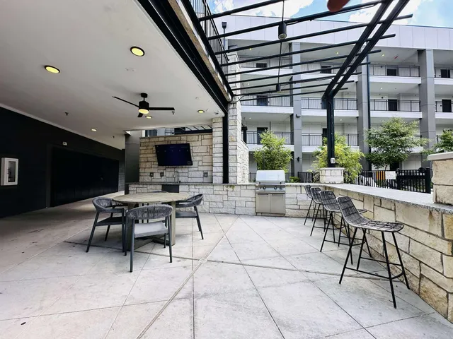 a outdoor space with lots of tables a chair and a fireplace
