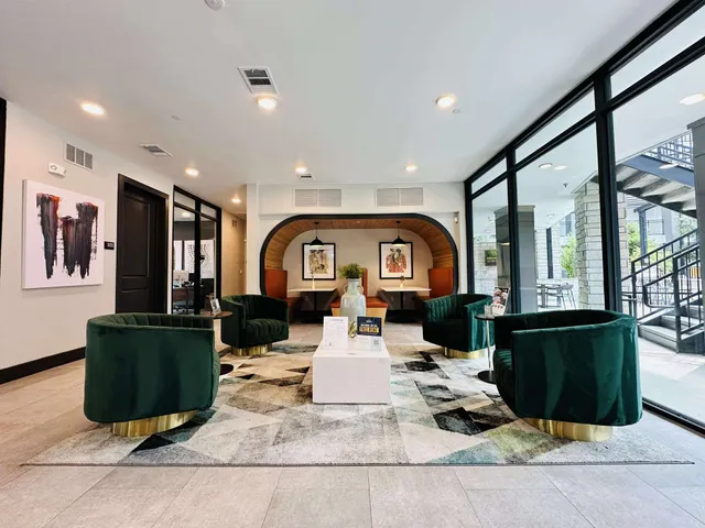 a living room with fireplace furniture and a large window