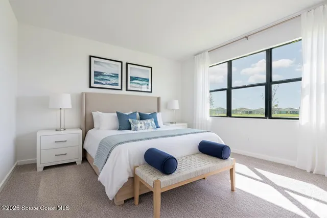 a bedroom with bed and a window