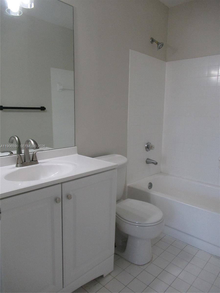 6825 Southwest 45th Lane, Unit 12 Miami, FL 33155 - Photo 11 of 17 a bathroom with a sink a toilet and shower