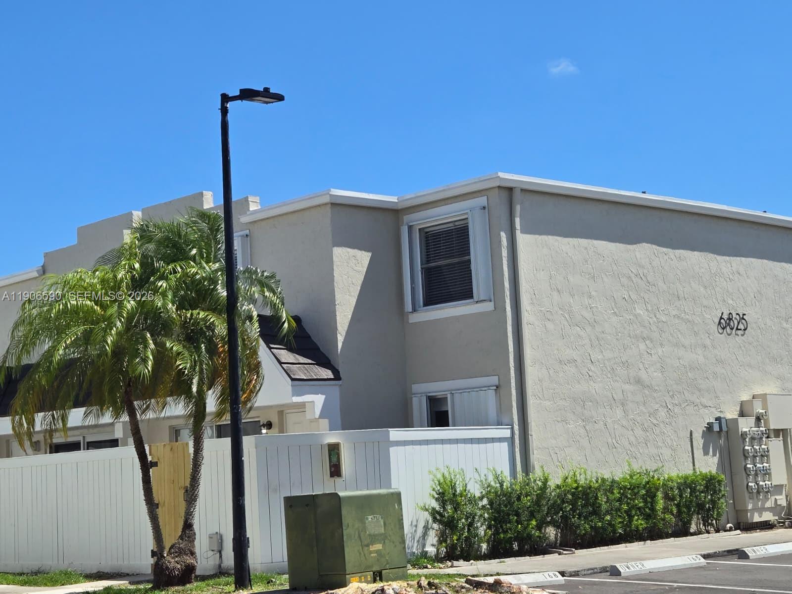 6825 Southwest 45th Lane, Unit 12 Miami, FL 33155 - Photo 17 of 17 a front view of a house with plants