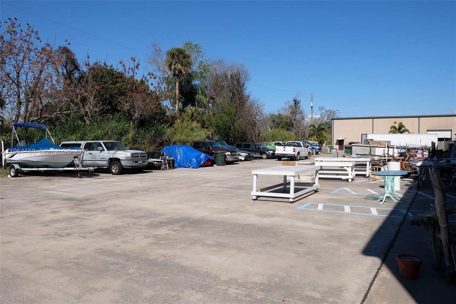 5271 Highway 441 Okeechobee, FL 34974 - Photo 14 of 15 a swimming pool with outdoor seating and a garden