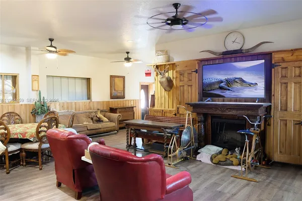 a living room with furniture a flat screen tv and a fireplace
