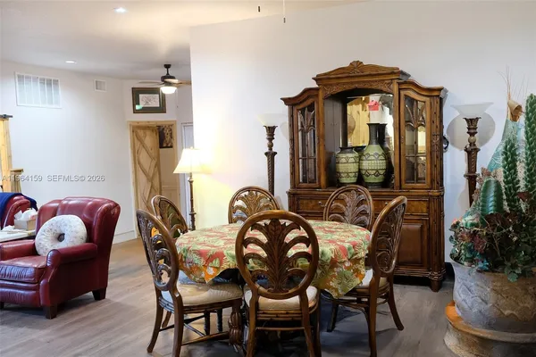 a view of a dining room with furniture and chandelier