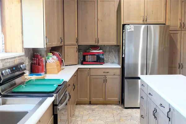a kitchen with kitchen island a counter top space and cabinets