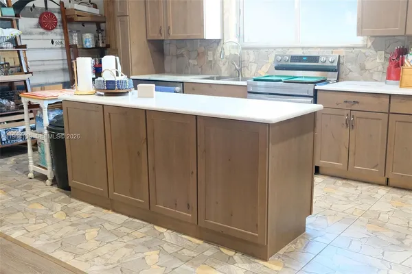 a kitchen with stainless steel appliances a sink and cabinets